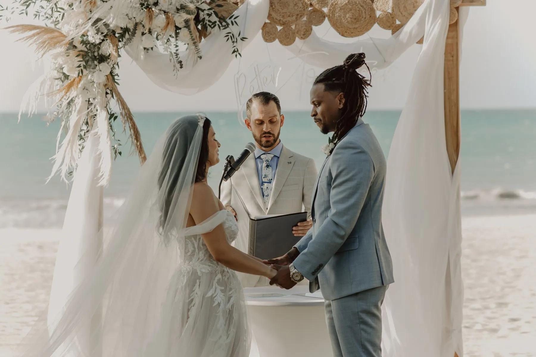 Couple exchanging vows at a beach ceremony