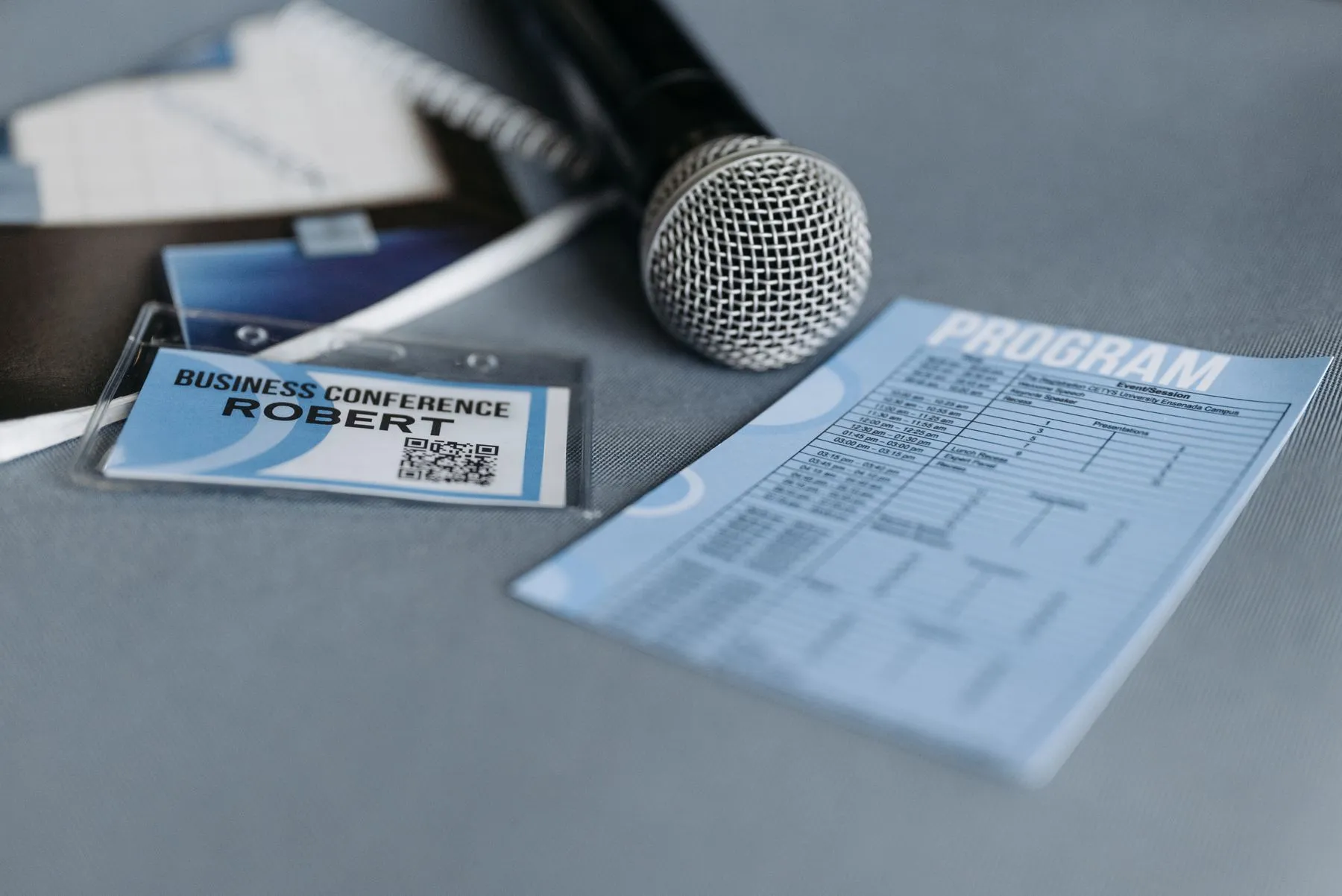 Microphone, badge and program prepared for a conference