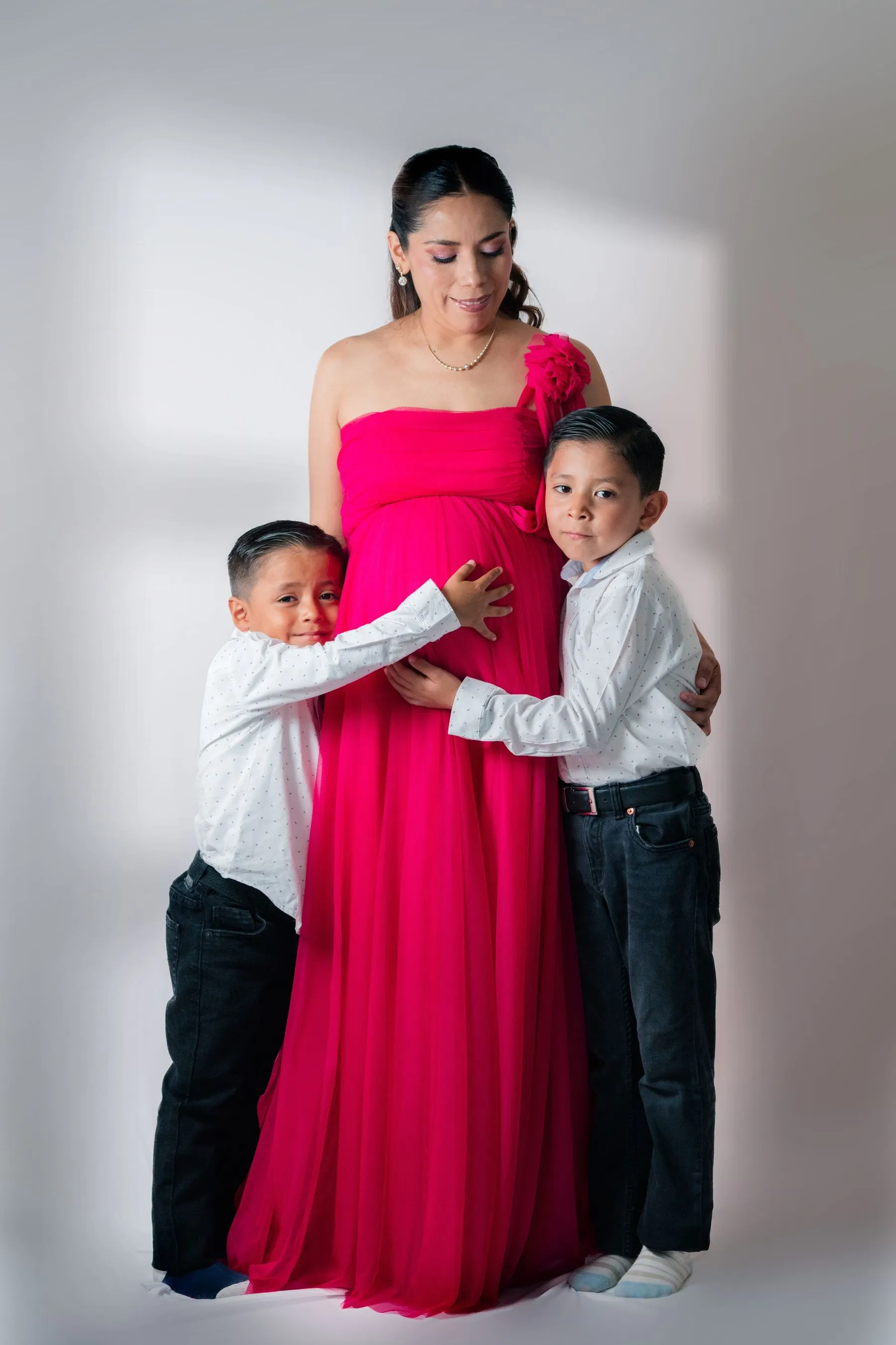 Family gathered together for a maternity portrait