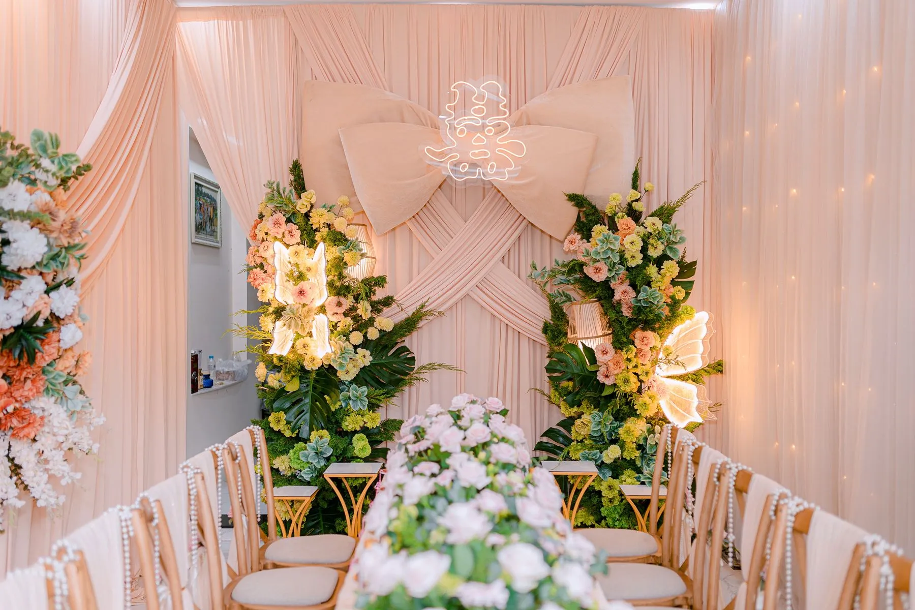 Floral wedding ceremony installation in a bright interior