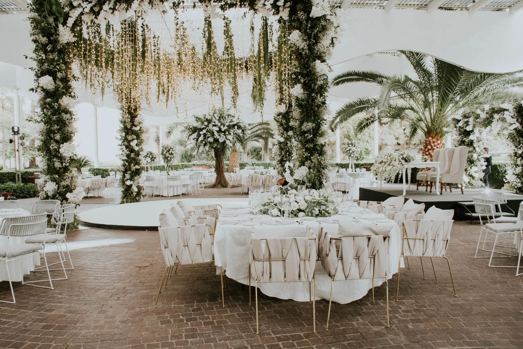 Garden wedding reception glowing with string lights