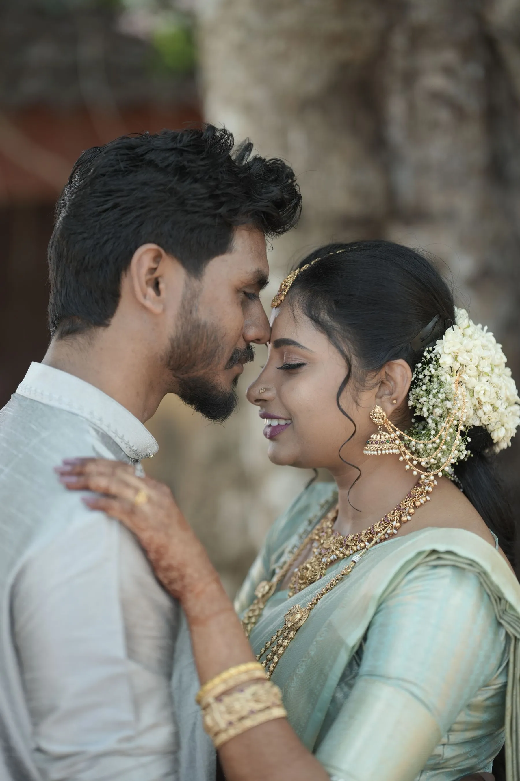 Couple in traditional wedding attire in warm outdoor light