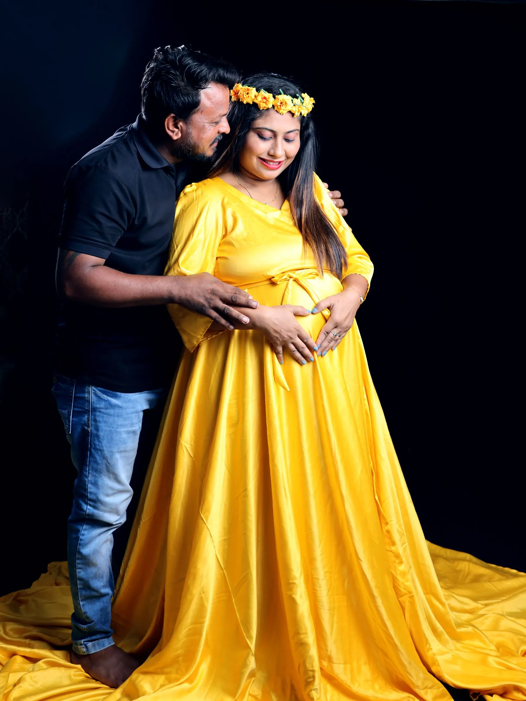 Expectant parents embracing during a maternity session