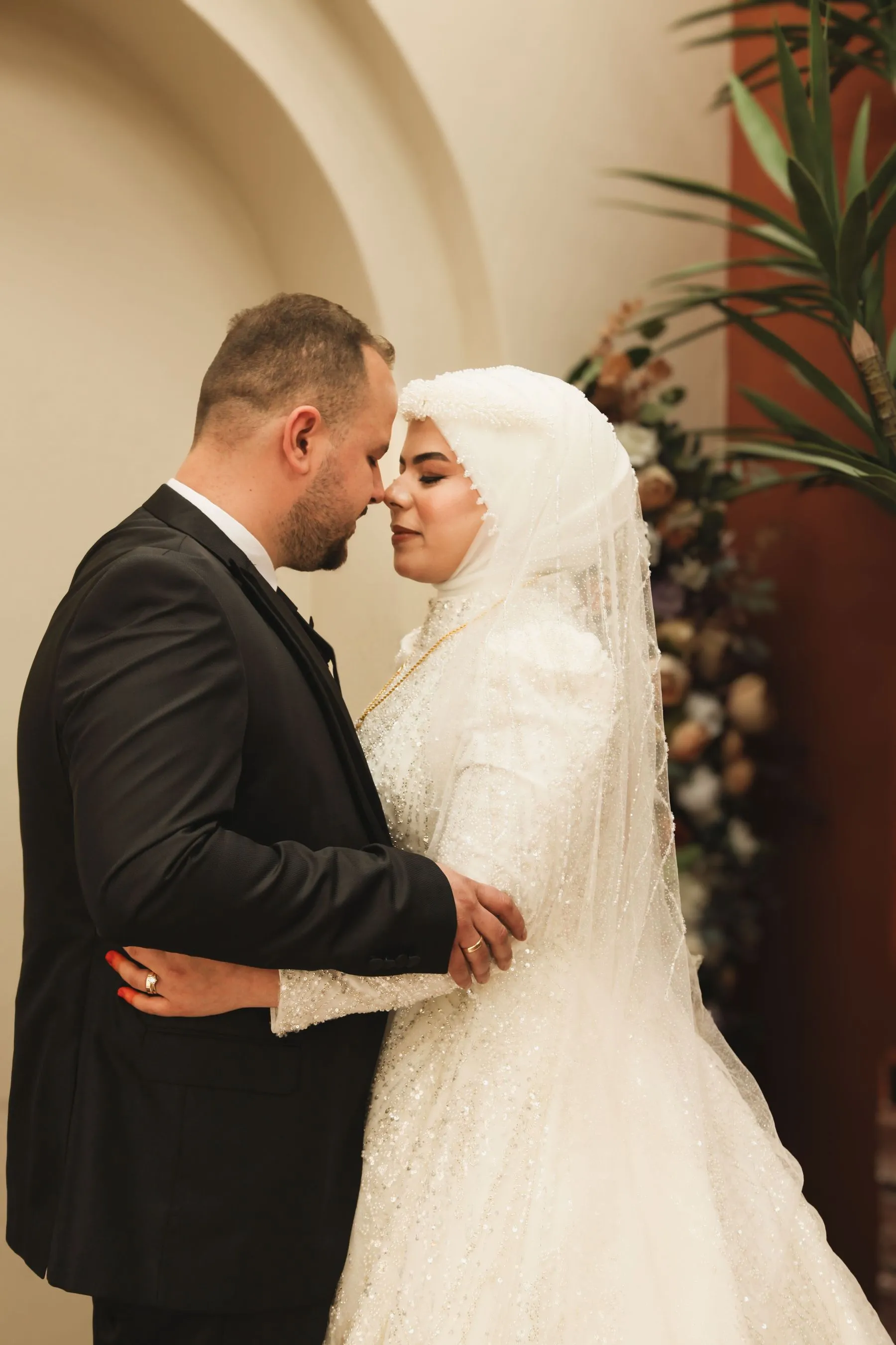 Muslim wedding couple sharing a quiet embrace