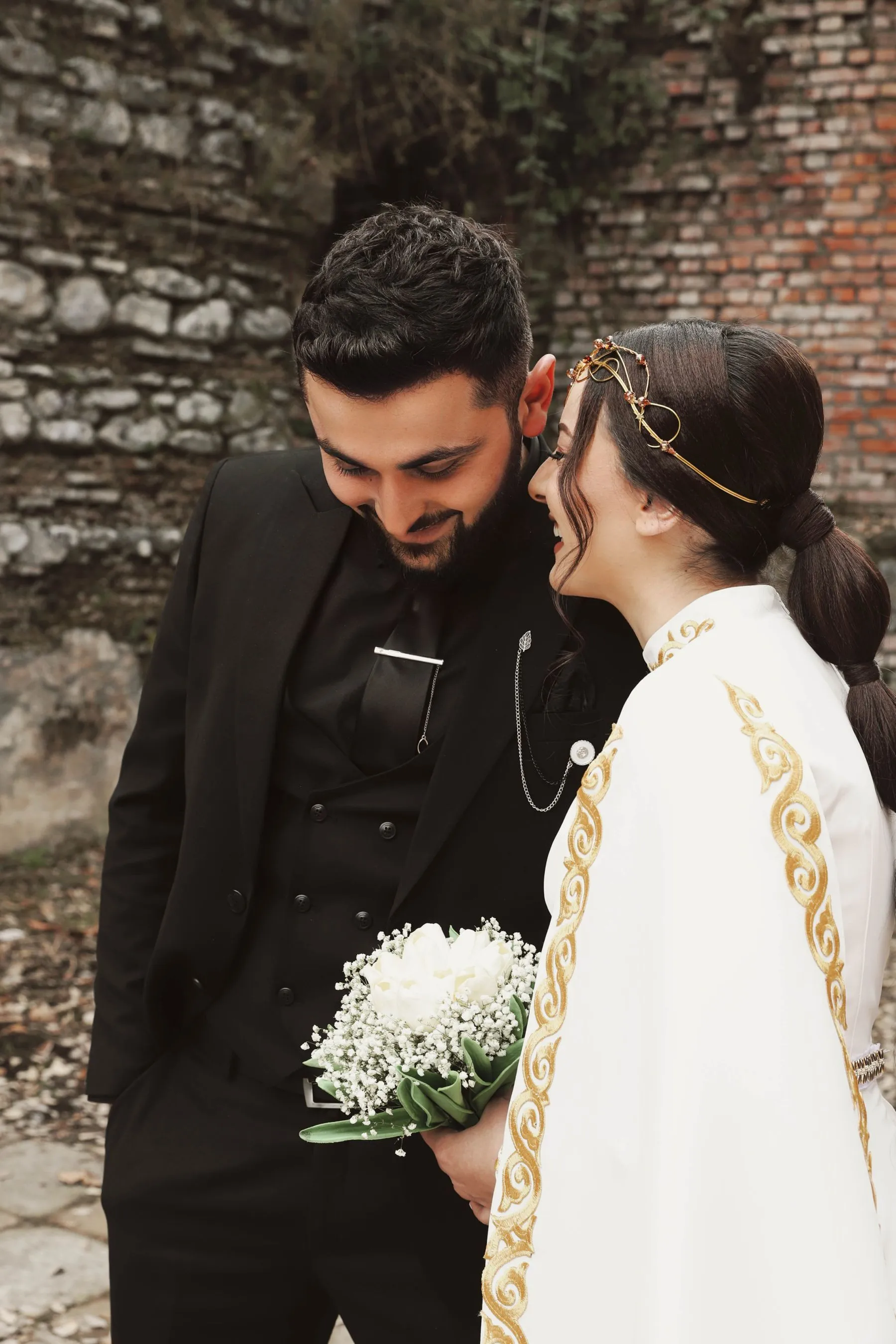 Couple sharing a conversation at an outdoor wedding
