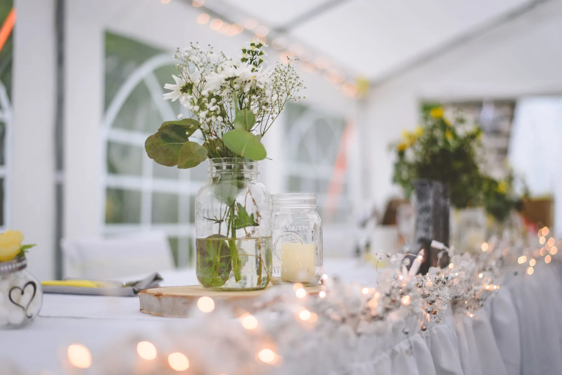 Reception room prepared beneath warm string lights